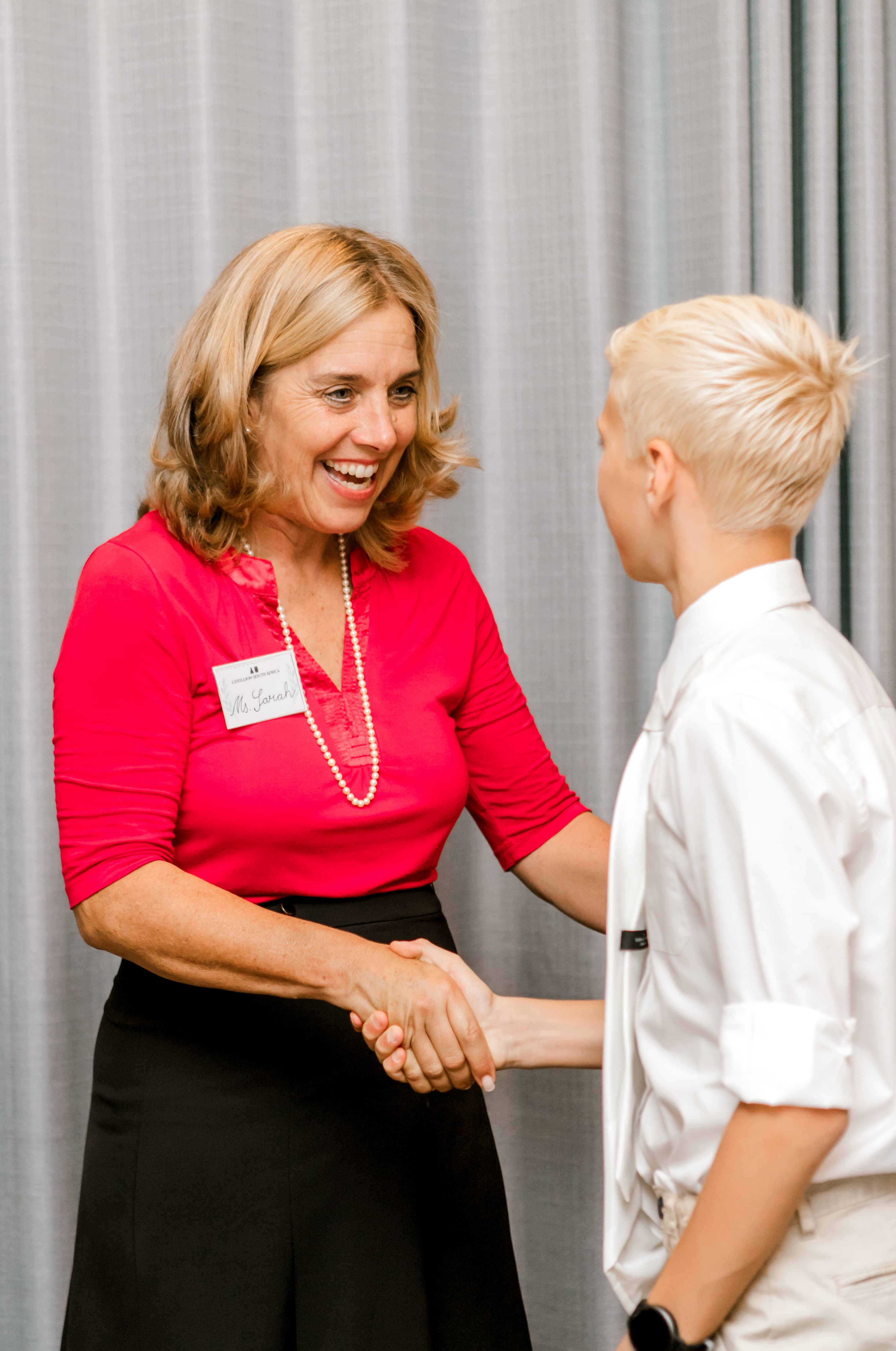 Ms. Sarah greeting a student